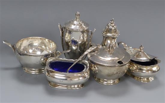 A stylish three piece silver condiment set, Birmingham, 1934 and one other three piece silver condiment set.